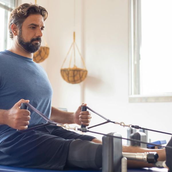 Man focused during a complex balance and strength exercise.